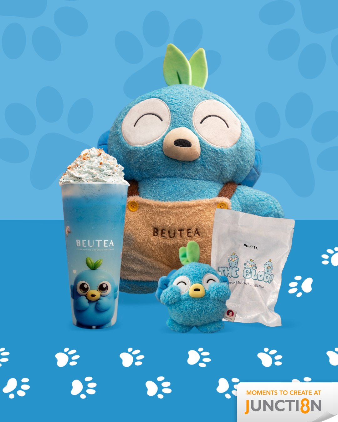 A cup of BEUTEA's White Orchid Milk Tea next to an adorable Bloop plush toy.
