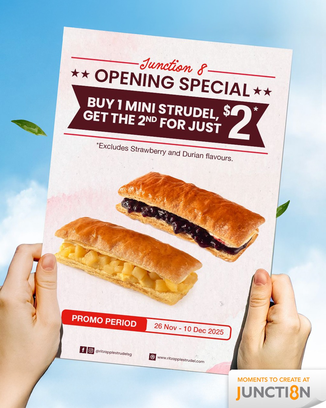 A freshly baked, golden-brown apple strudel with a dusting of powdered sugar, presented on a serving platter.