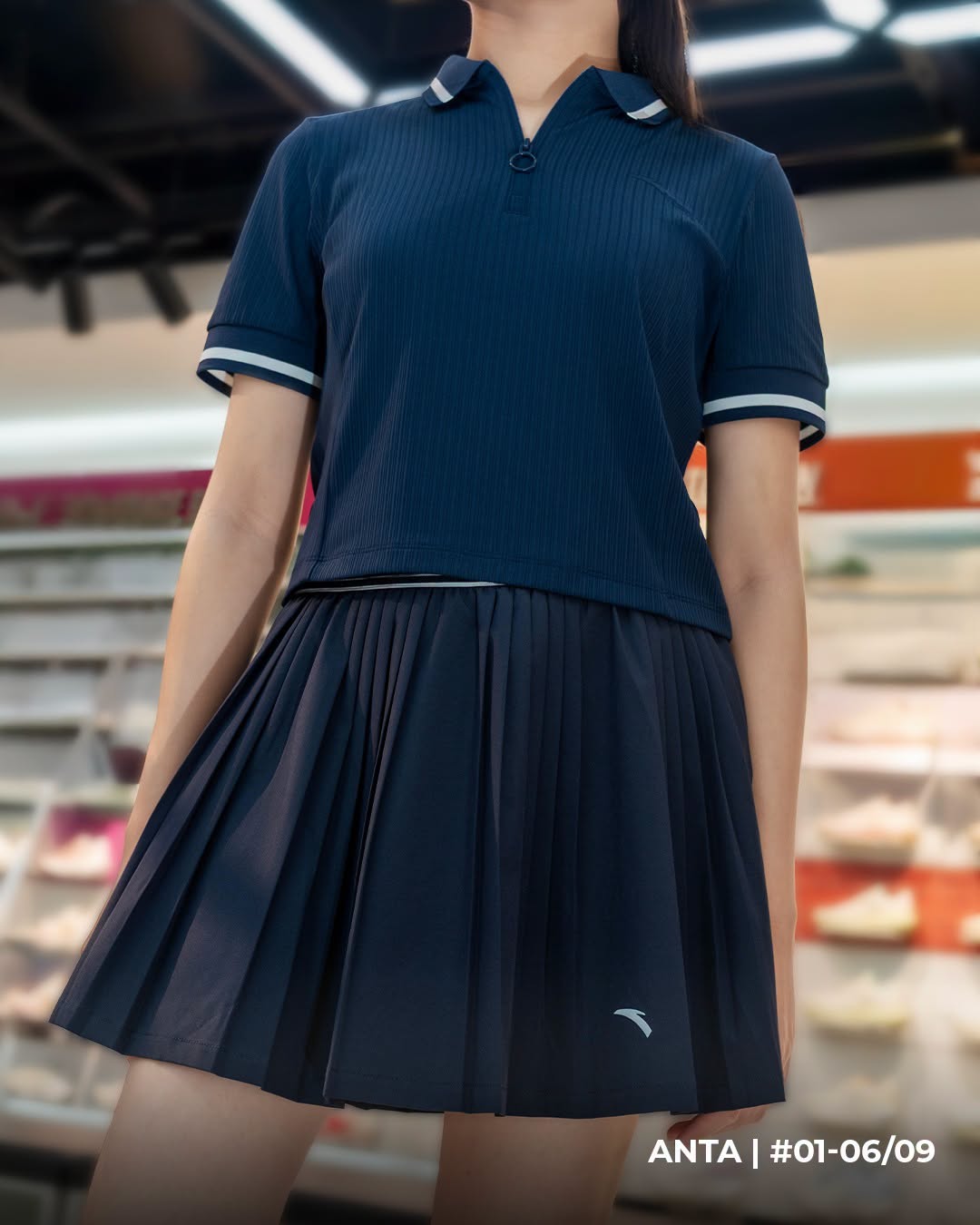 ANTA navy ribbed polo shirt and pleated mini skirt
