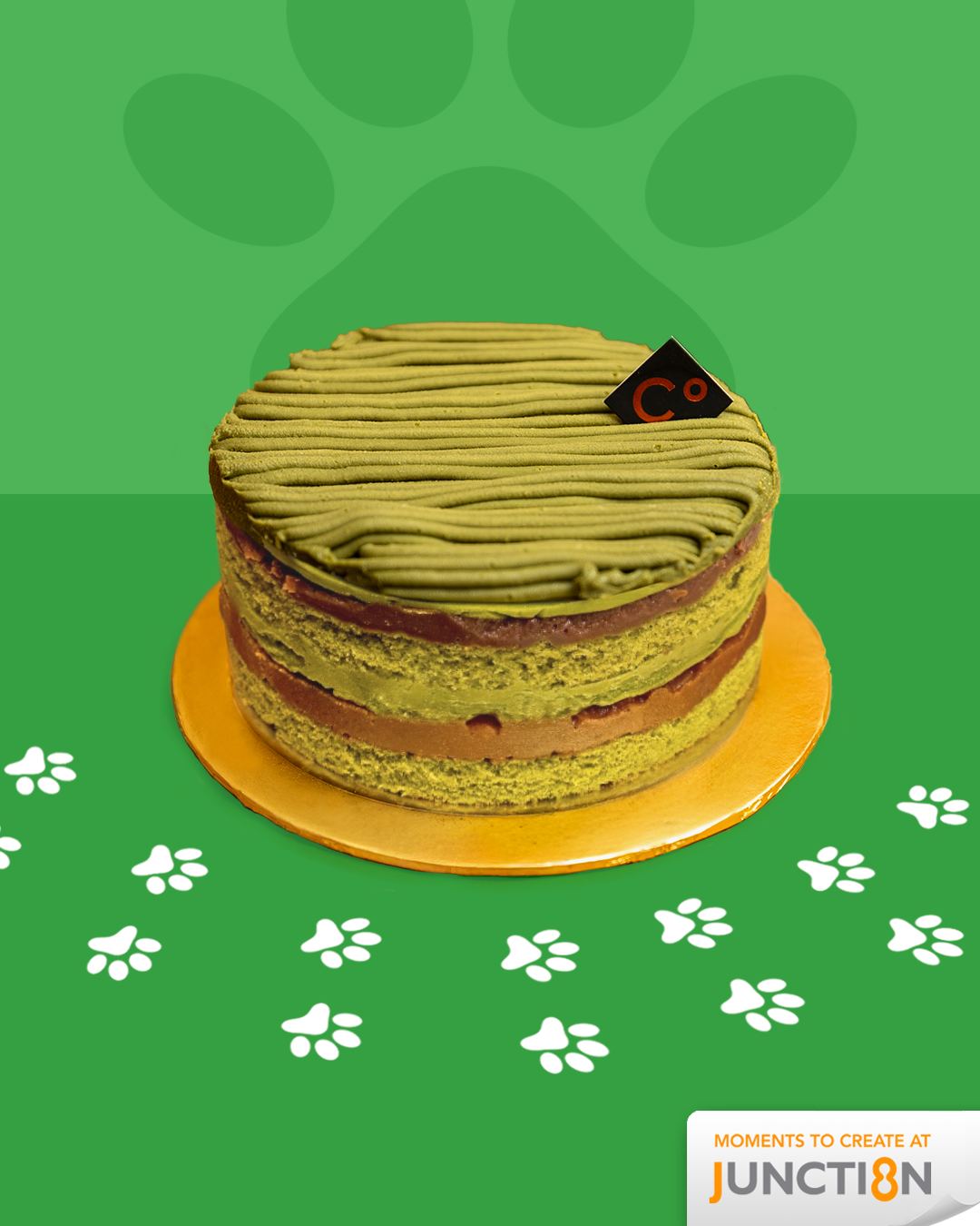 A stunning close-up of Chocolate Origin's Matcha Opera Cake, showcasing its distinct layers of green matcha, dark chocolate, and creamy filling.