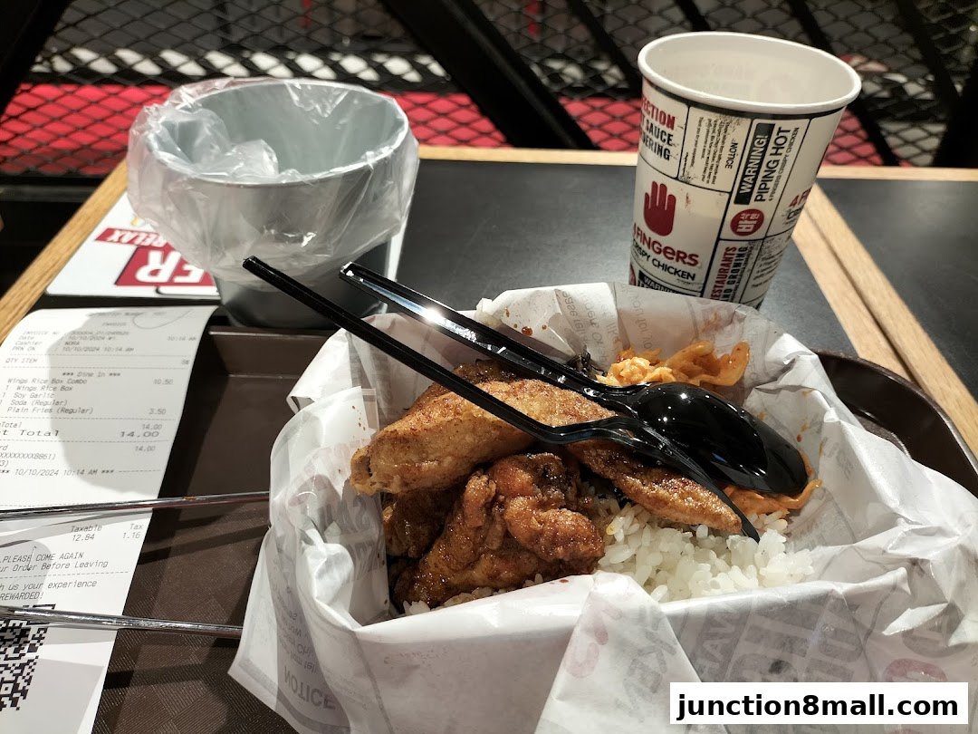 A meal from 4 Fingers Crispy Chicken with rice, chicken wings, fries, a drink, and a receipt.