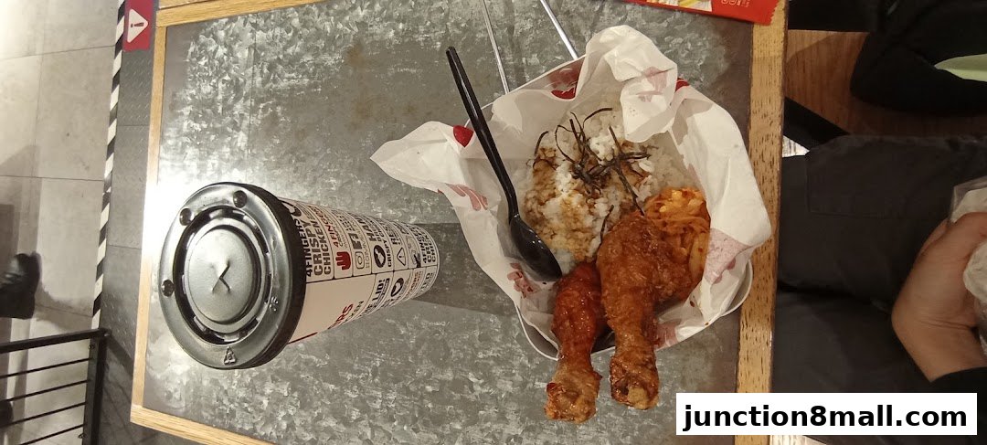 A meal from 4 Fingers Crispy Chicken featuring fried chicken, rice, and a drink.