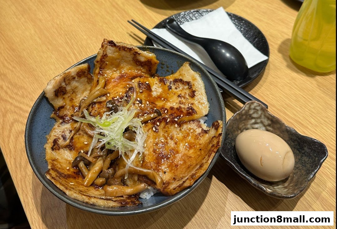 A delicious bowl of Aburi-EN's signature pork rice bowl with mushrooms and a side of seasoned egg.