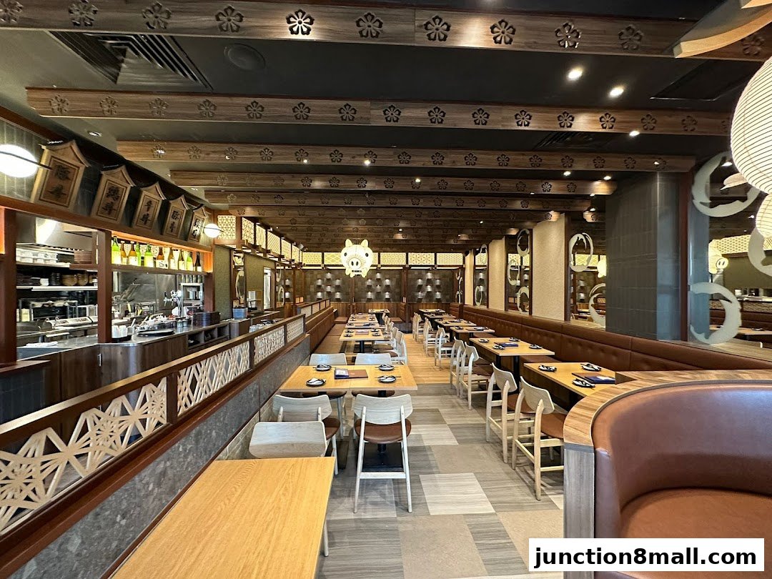 Interior view of a Japanese restaurant with wooden decor and seating arrangements.