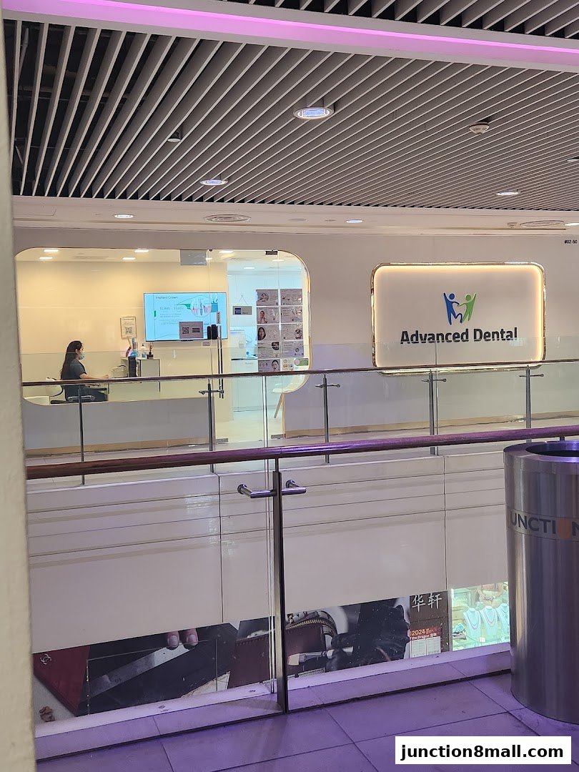 The exterior of Advanced Dental Bishan, a modern dental clinic with a welcoming reception area.