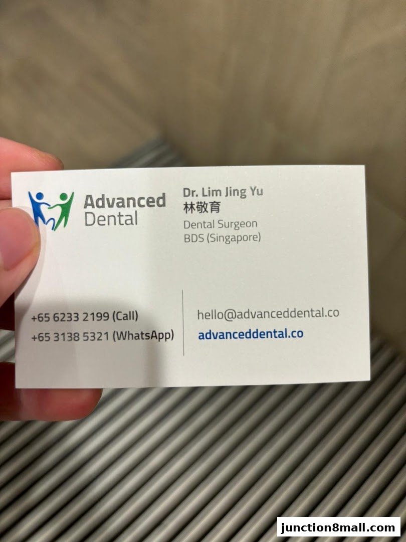 A business card for Advanced Dental, featuring contact information and a dental surgeon's details.