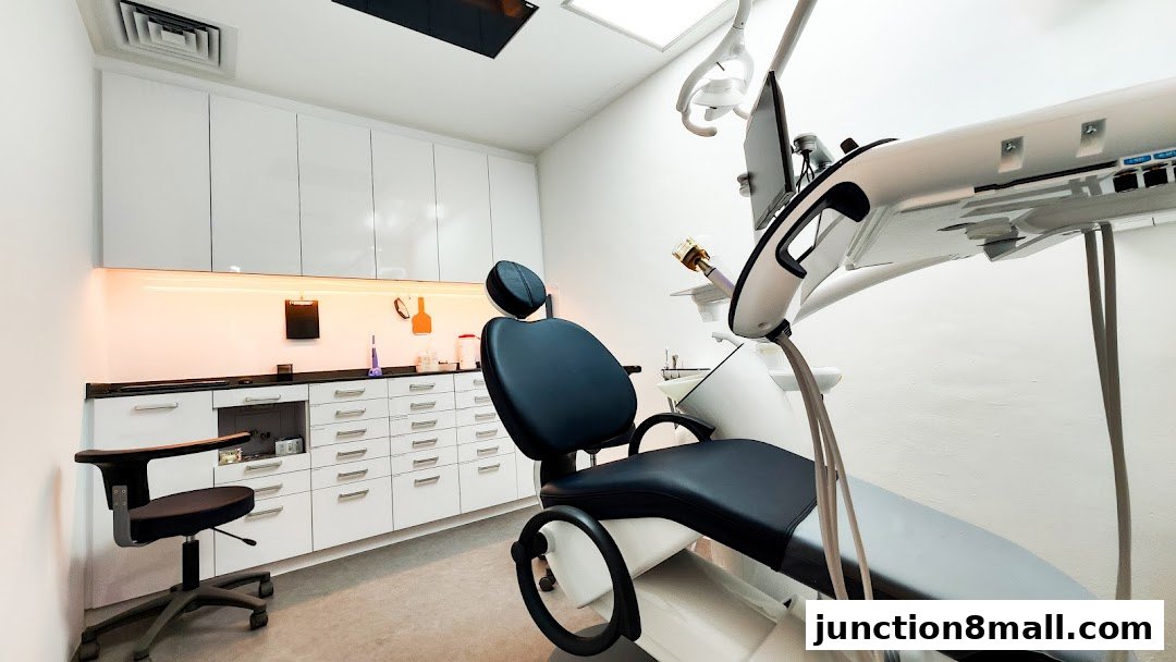 A modern dental examination room with a reclining chair and medical equipment.
