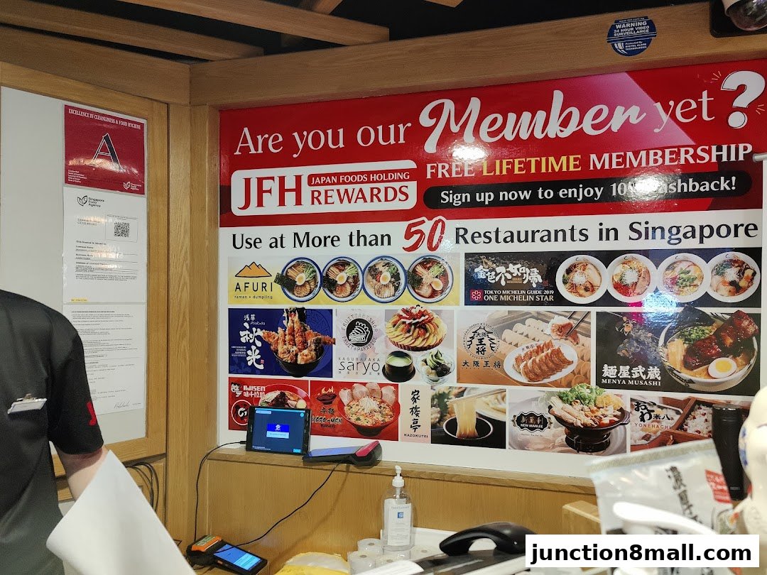 A wall display promoting JFH Rewards membership with images of various Japanese dishes.