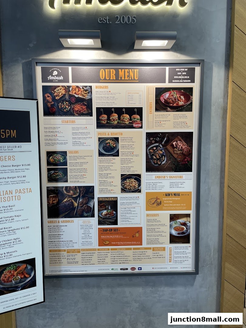 A menu board for Ambush restaurant, featuring burgers, pasta, grills, and desserts.