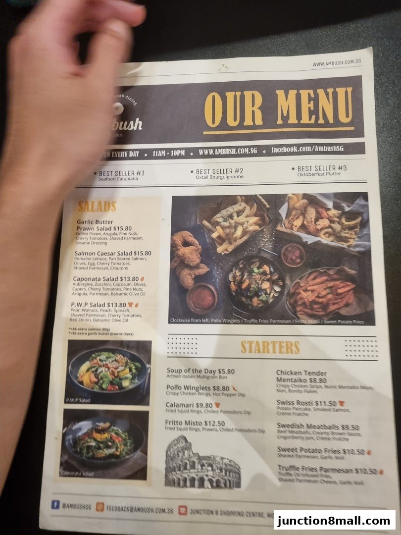 A menu from Ambush restaurant featuring salads and starters with accompanying images.