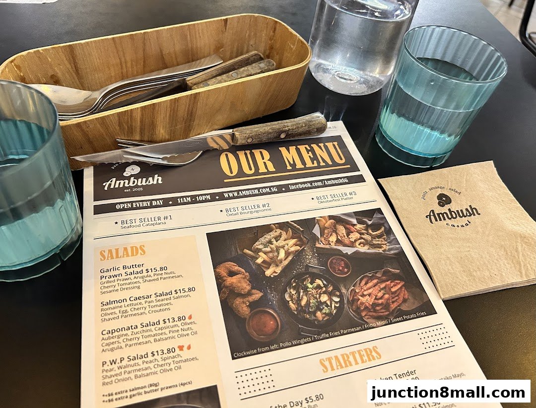 A menu from Ambush restaurant with salads and starters listed, along with cutlery and drinks.