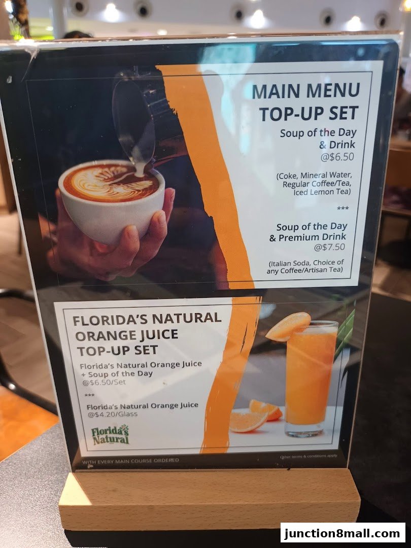 A menu board displaying soup and drink top-up sets and Florida's Natural Orange Juice.