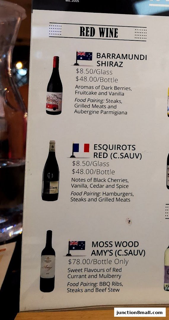 A menu featuring red wines with descriptions and food pairings.