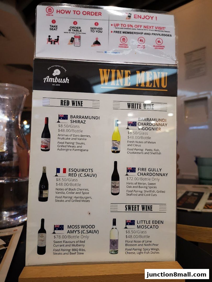 A wine menu from Ambush restaurant featuring red, white, and sweet wines with descriptions and food pairings.