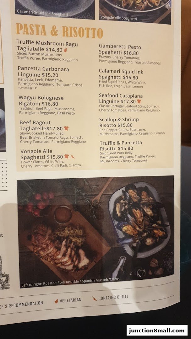 A menu featuring pasta and risotto dishes, with images of roasted pork knuckle and mussels.