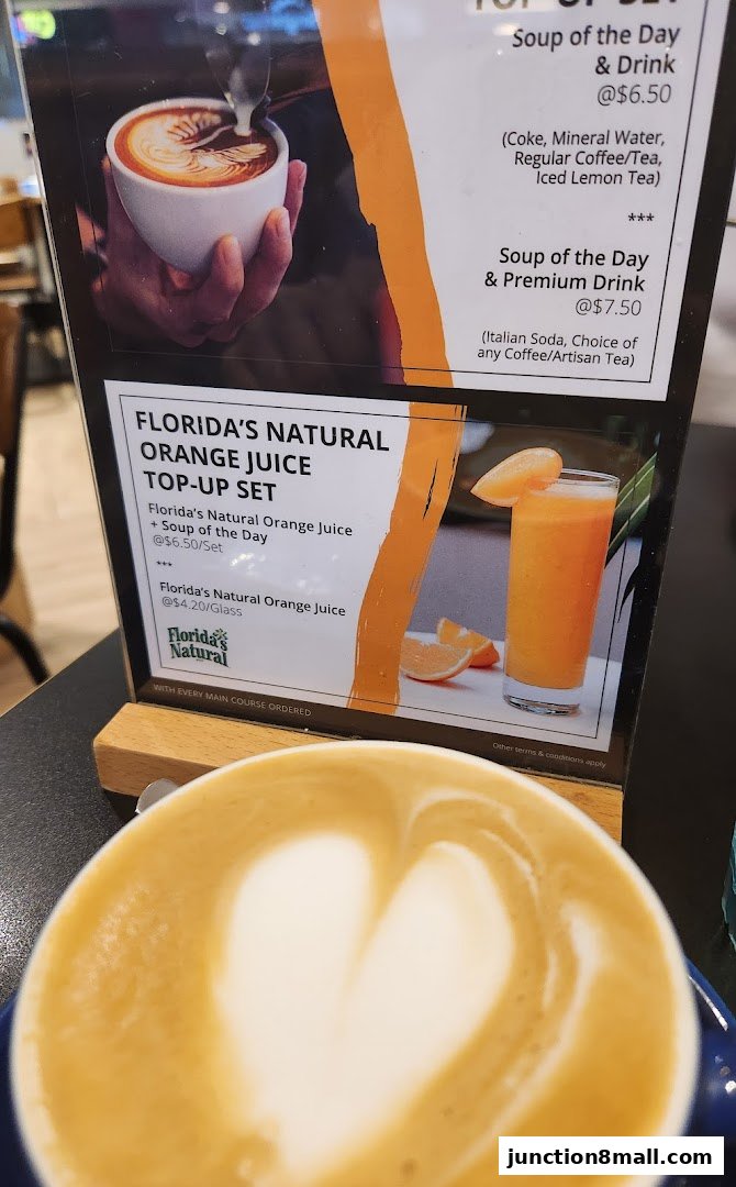 A menu board displays soup and drink specials, including orange juice top-up sets.