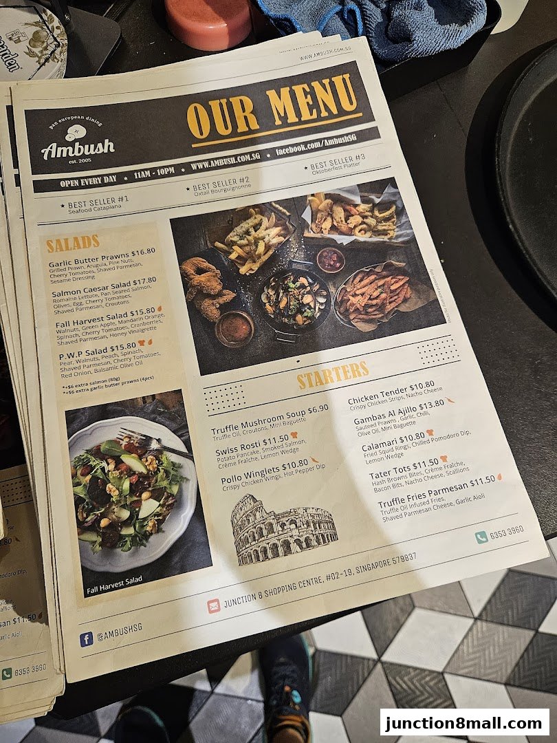 A menu from Ambush restaurant featuring salads and starters with appealing food photography.
