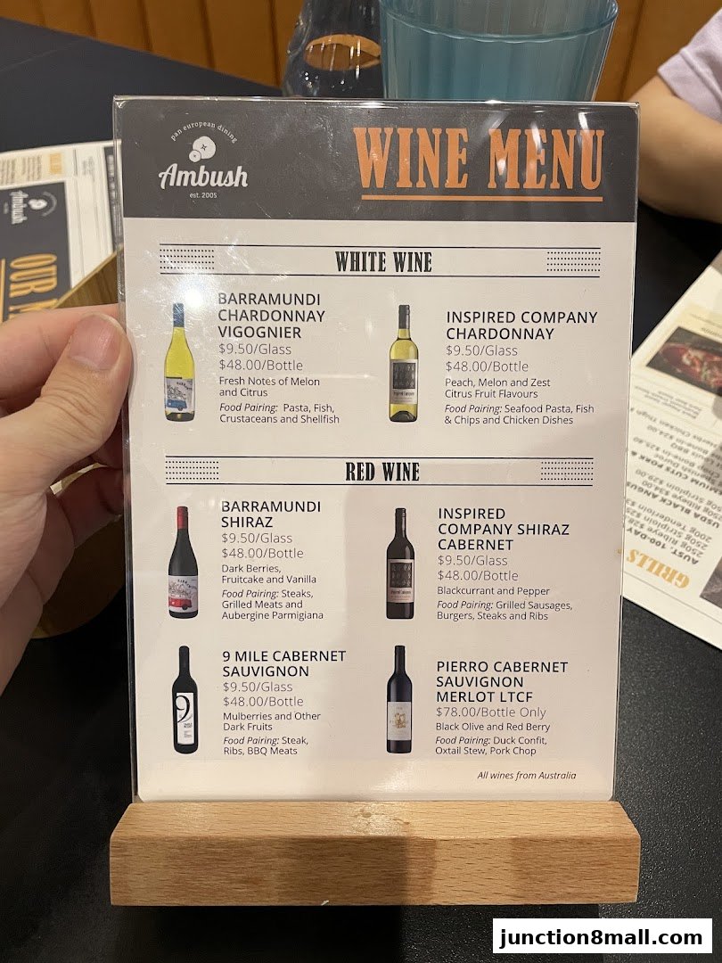 A wine menu from Ambush restaurant featuring white and red wines with descriptions and prices.