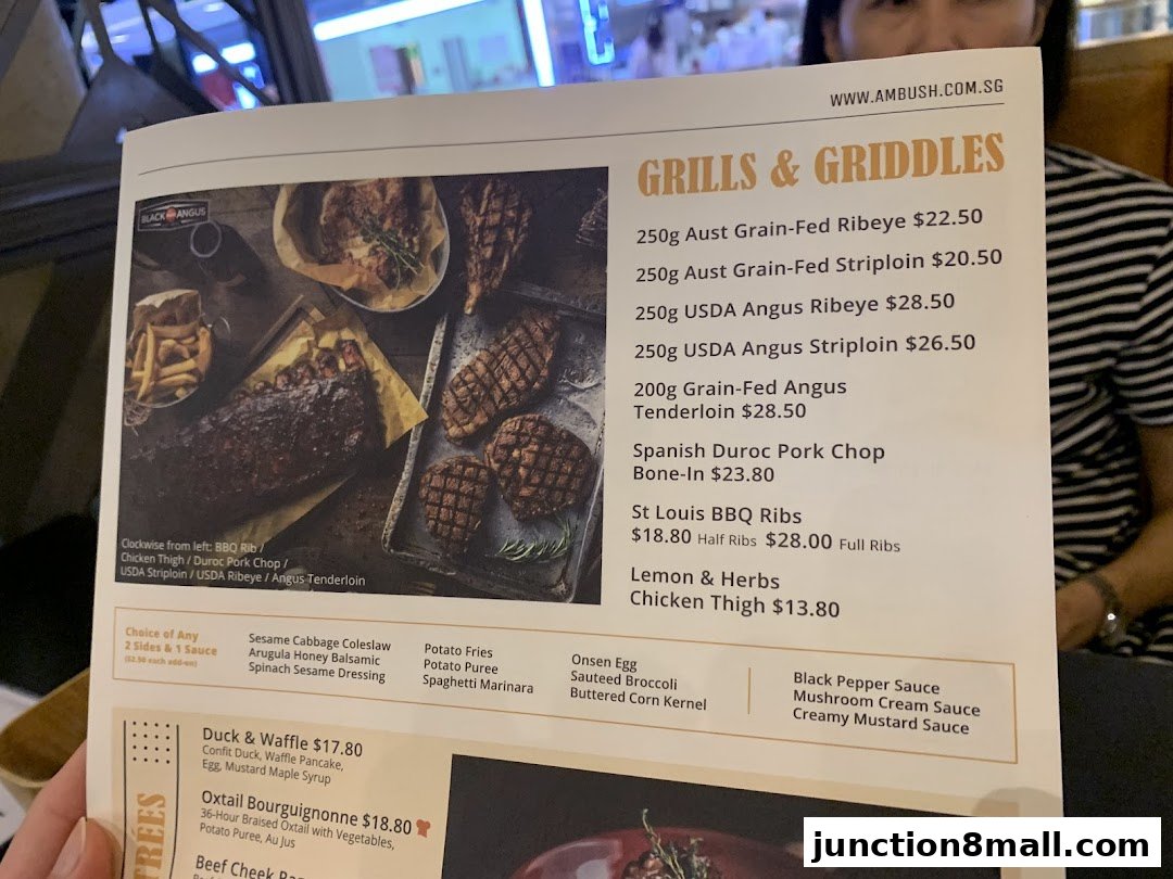 A menu from Ambush featuring grilled meats, sides, and signature dishes.