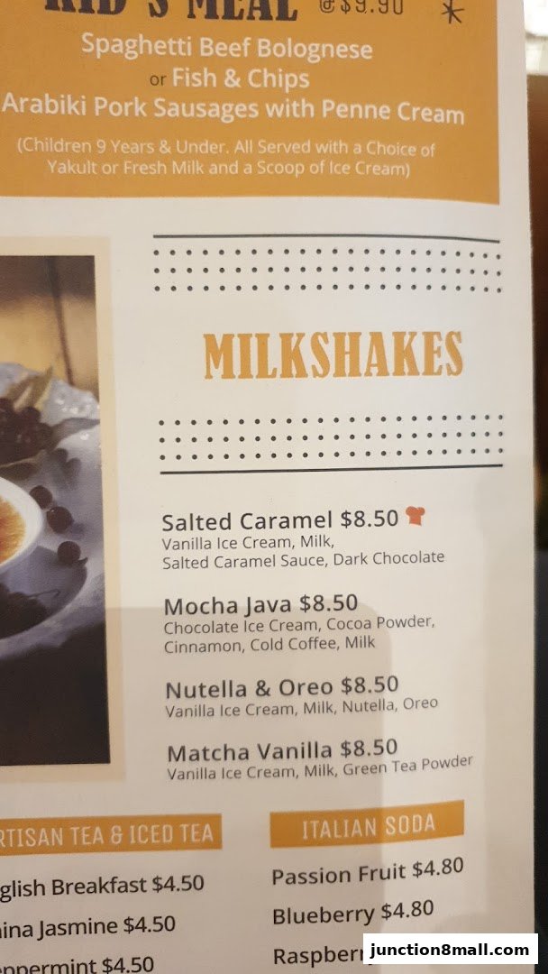 A menu featuring milkshakes, artisan teas, iced teas, and Italian sodas with prices.