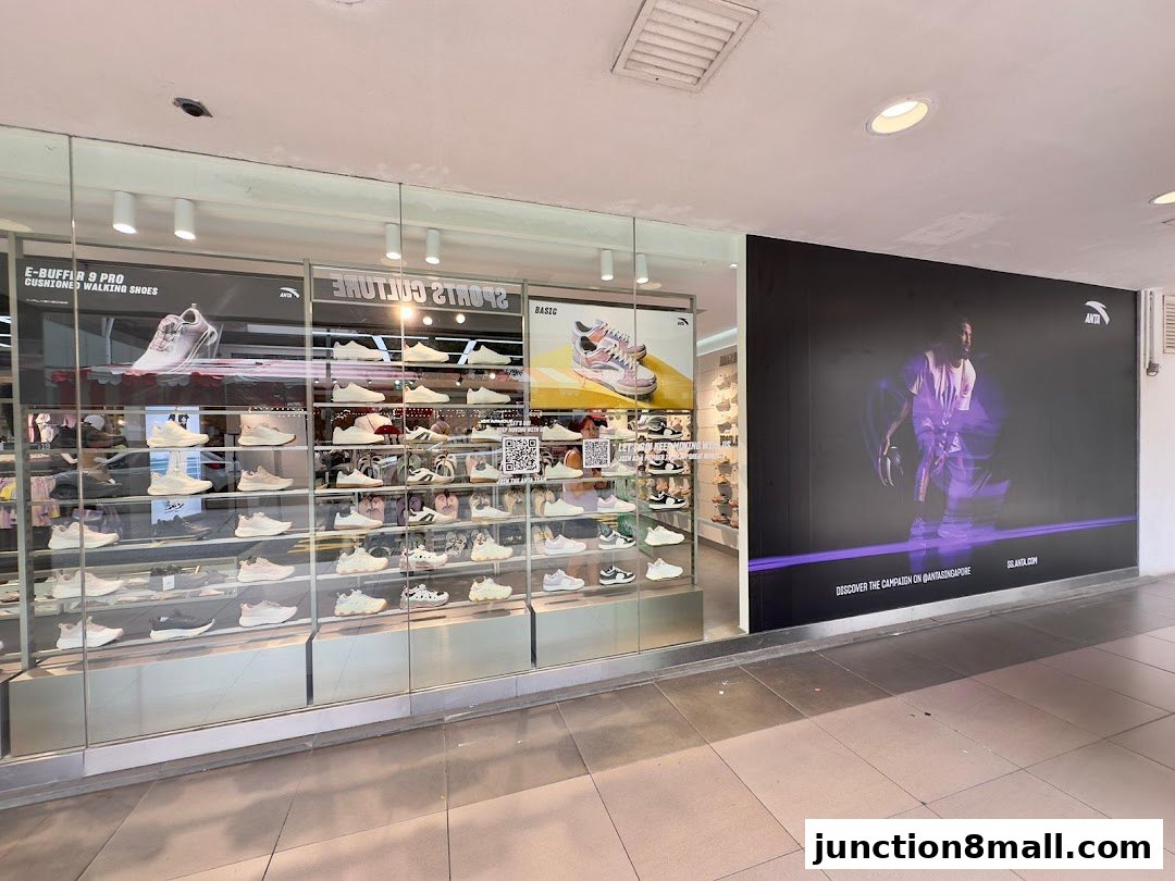Anta Junction 8 shoe store displaying various athletic footwear on shelves and a large promotional banner.