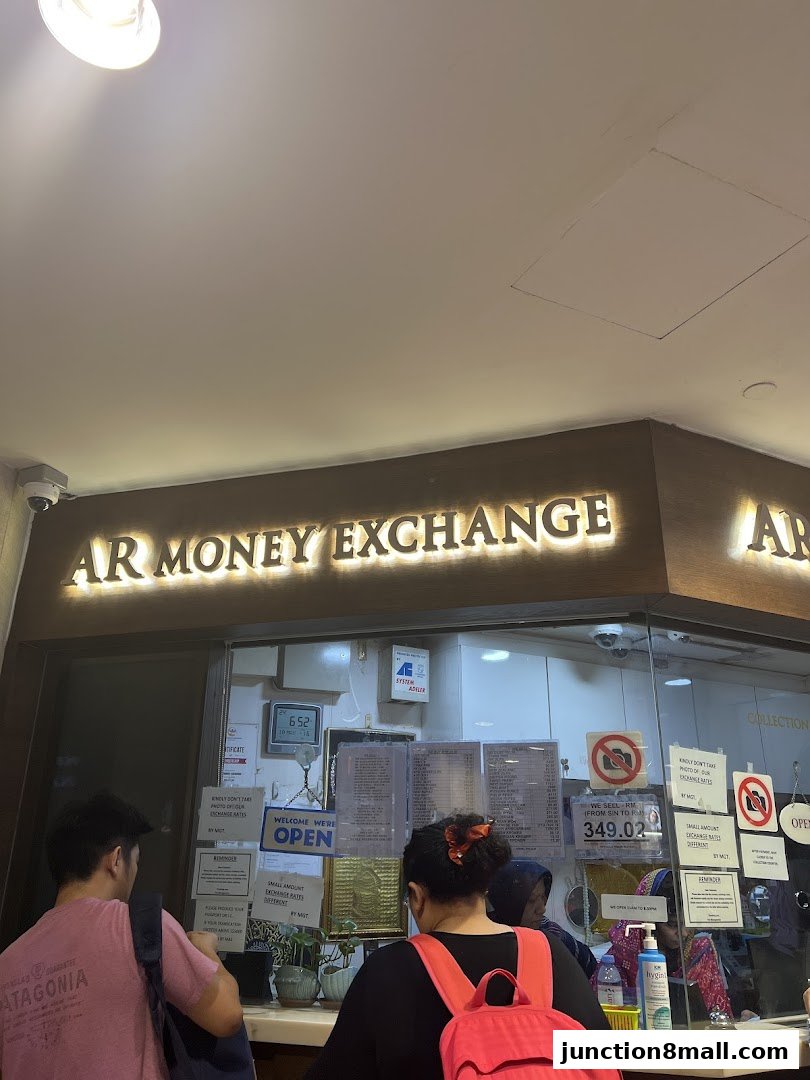 AR Money Exchange shop front with customers at the counter and exchange rate information displayed.