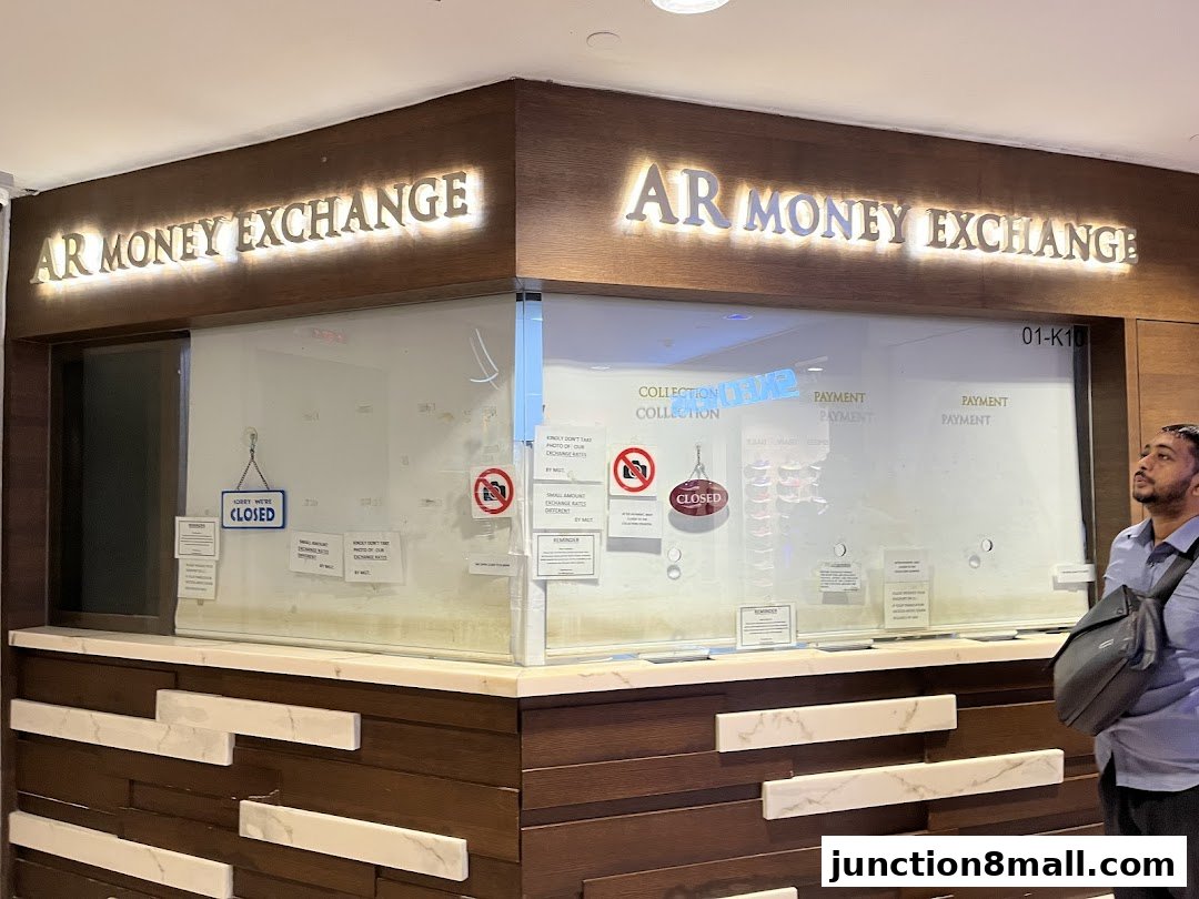 The AR Money Exchange shop front with illuminated signage and a 'Closed' sign.