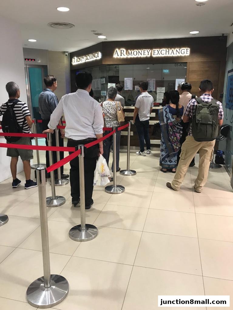 People queuing at AR Money Exchange for currency exchange services.
