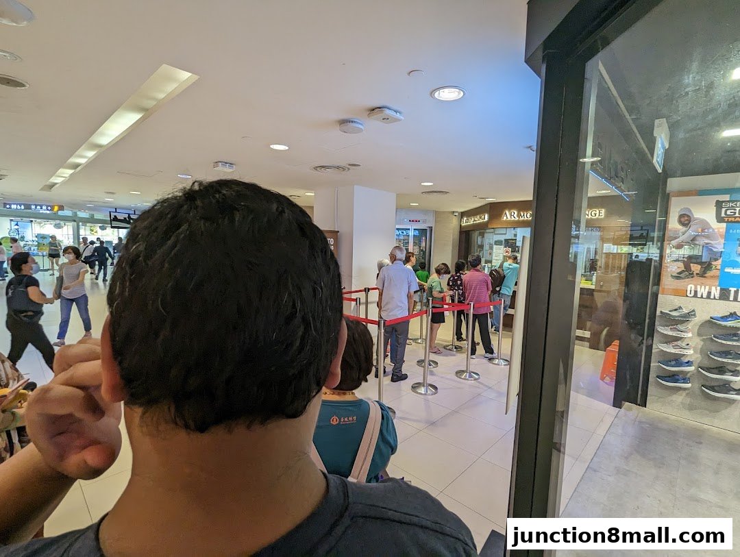 People queuing at AR Money Exchange with a Skechers store visible to the right.