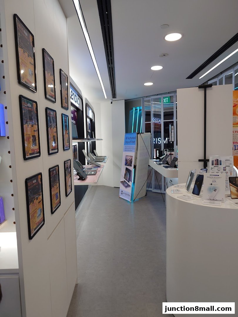 Interior view of a modern electronics store showcasing various devices and promotional materials.
