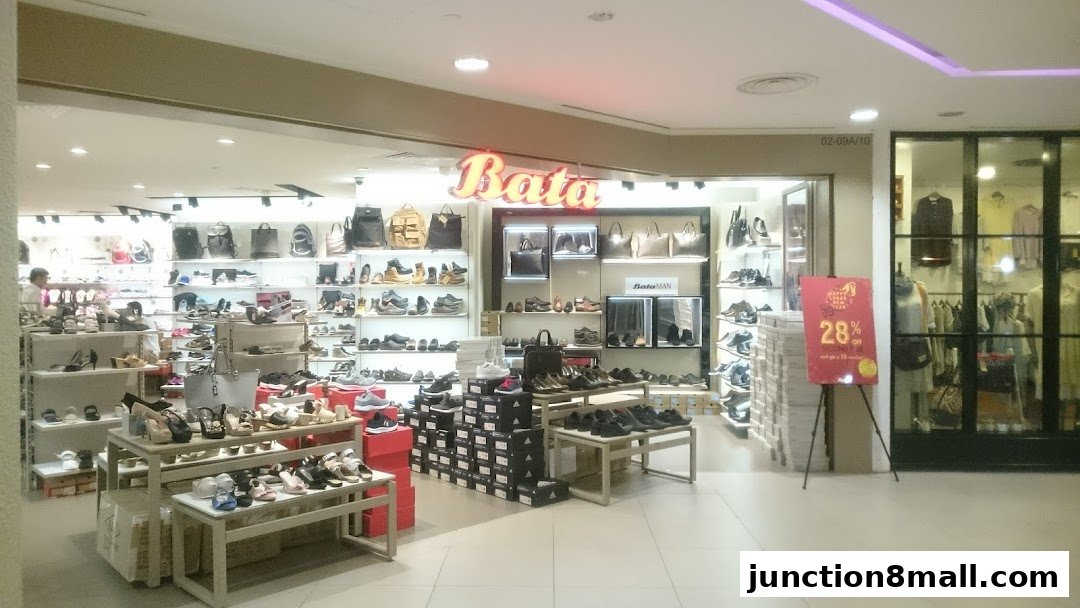 Interior view of a Bata shoe store showcasing a wide variety of footwear and bags.