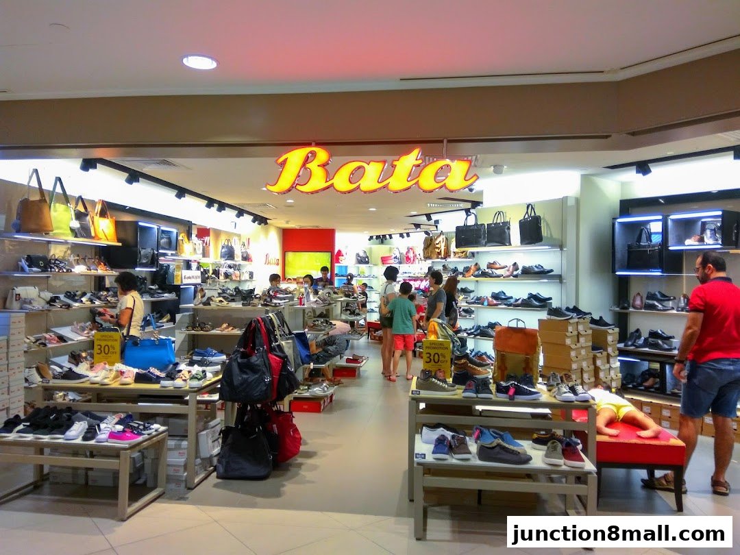 Interior view of a Bata shoe store with various footwear and handbags on display.