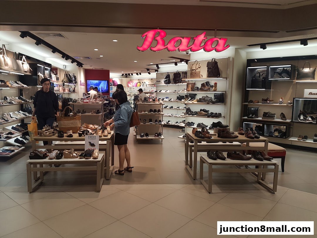 Interior view of a Bata shoe store showcasing a wide variety of footwear and handbags.