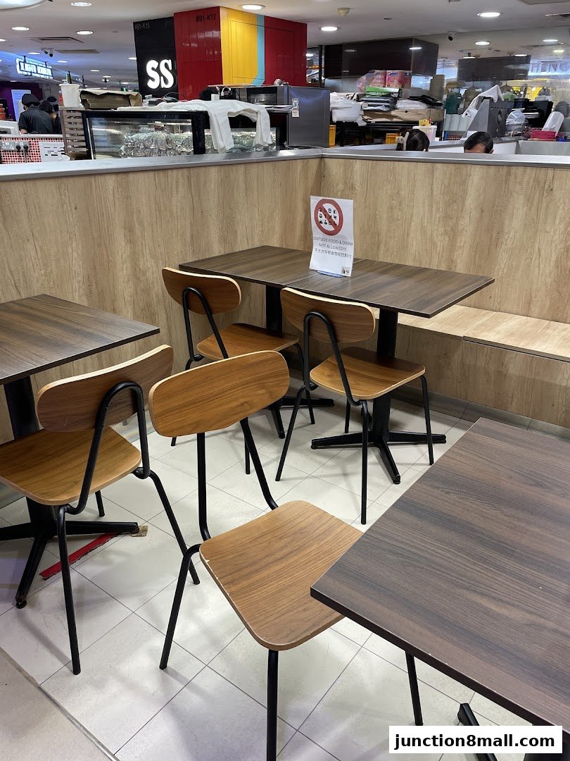 Interior view of BBQ Express with tables and chairs, and a counter in the background.