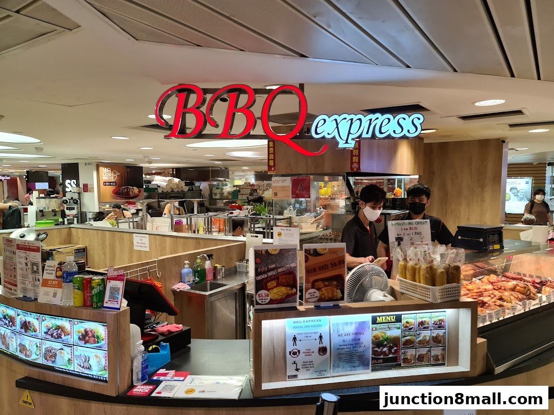 BBQ Express shop counter with staff, food displays, and menu boards.