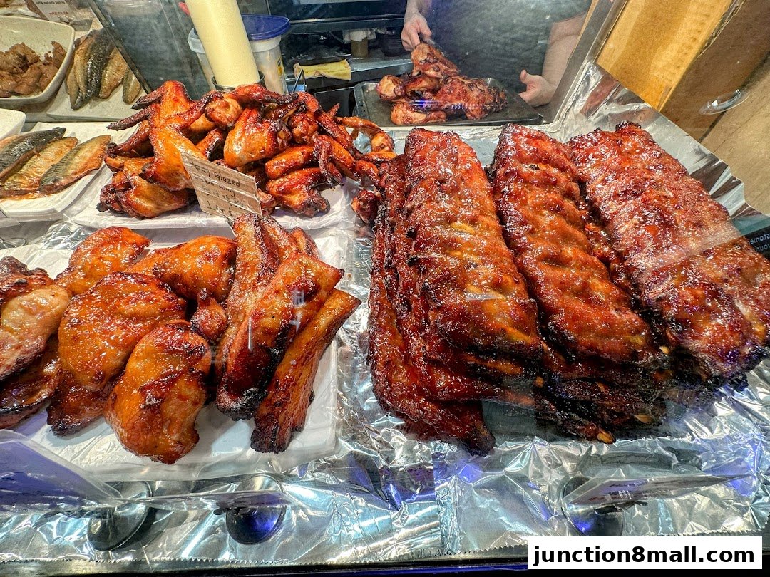 A display of delicious BBQ ribs and chicken wings, glistening with sauce.