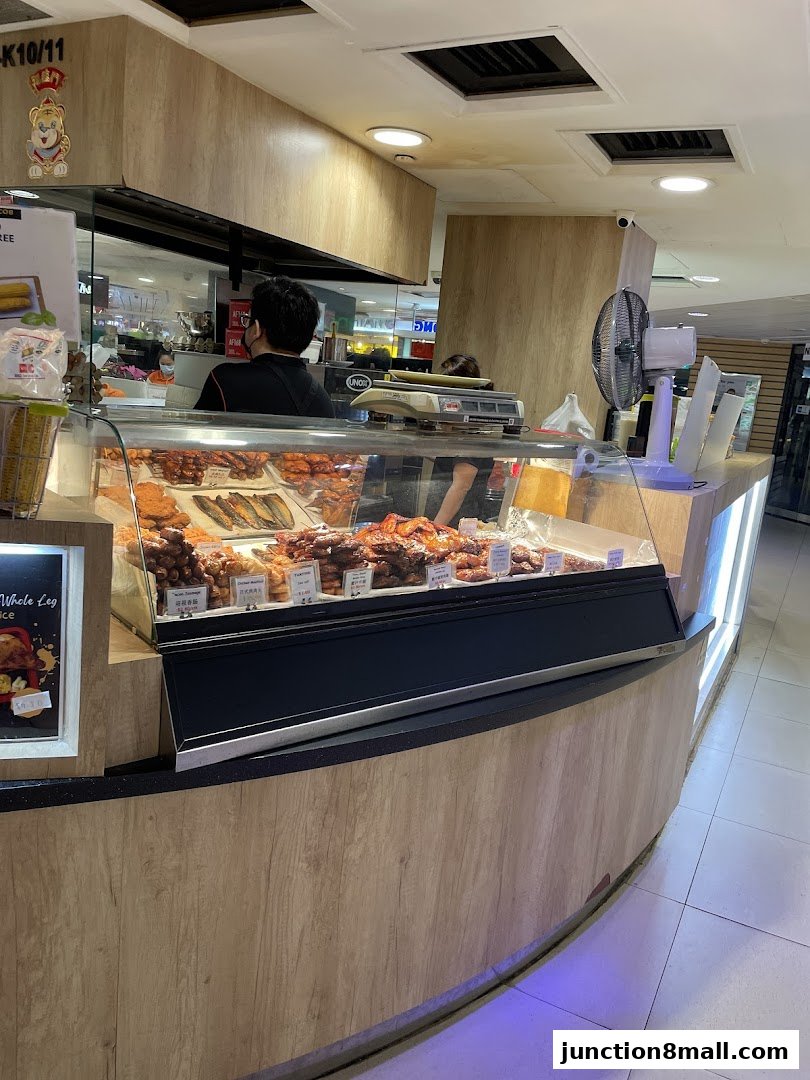 A display counter filled with various roasted meats and poultry at BBQ Express.