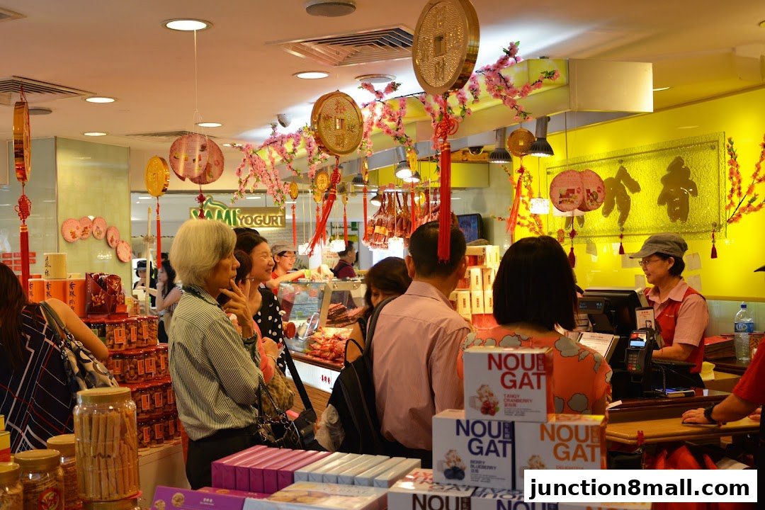 Customers shop for festive treats at Bee Cheng Hiang, decorated with traditional Chinese New Year ornaments.