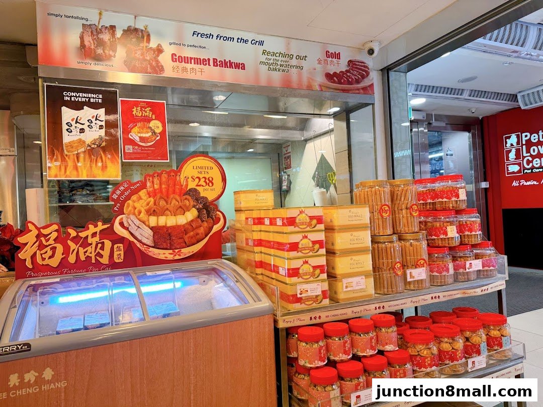Bee Cheng Hiang shop displaying gourmet bakkwa, fortune pen cai, and various snacks.