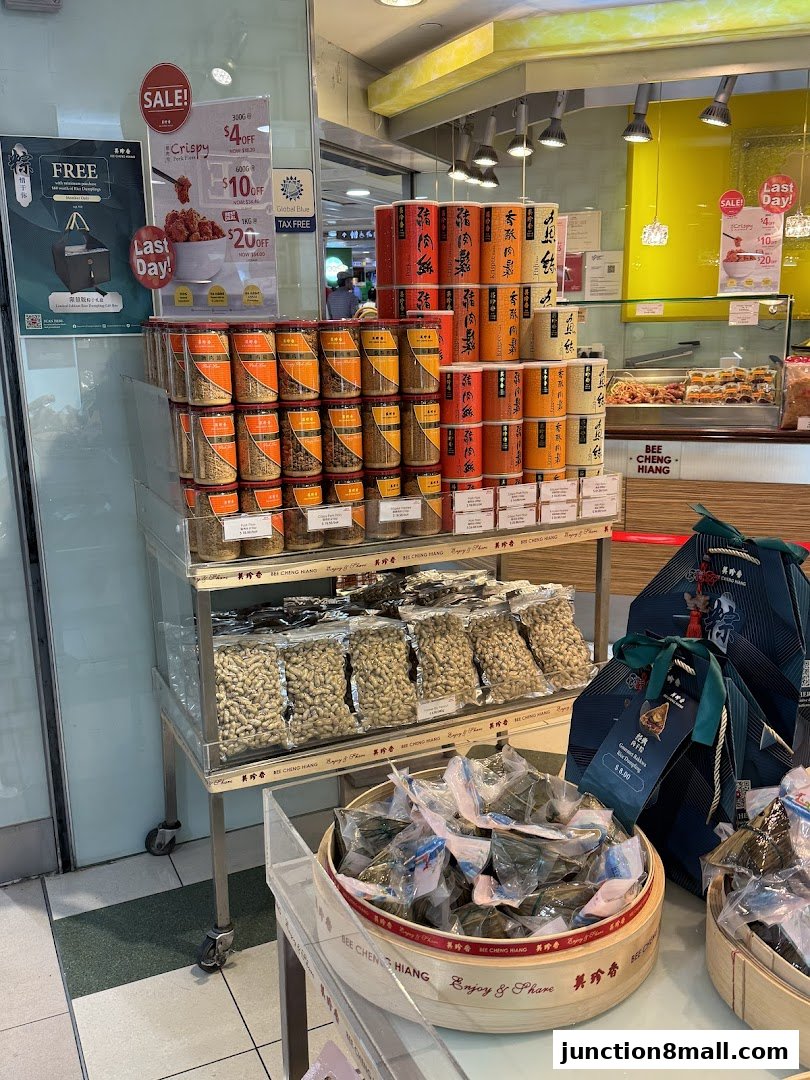 Bee Cheng Hiang shop interior displaying various packaged snacks and promotional signs.