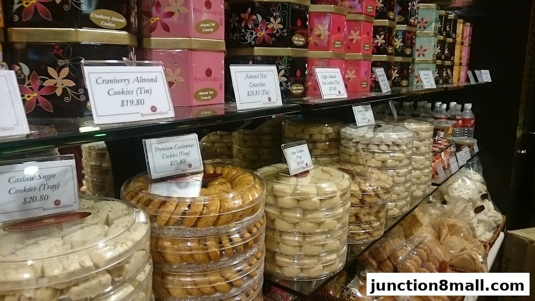 A display of various cookies and snacks in tins and clear containers at Bengawan Solo.