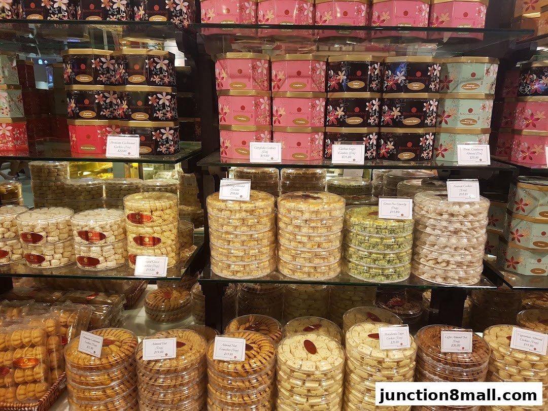 A display of various cookies and biscuits in decorative tins and clear plastic containers.