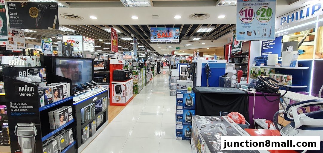 Interior view of an electronics store showcasing various brands and promotions.