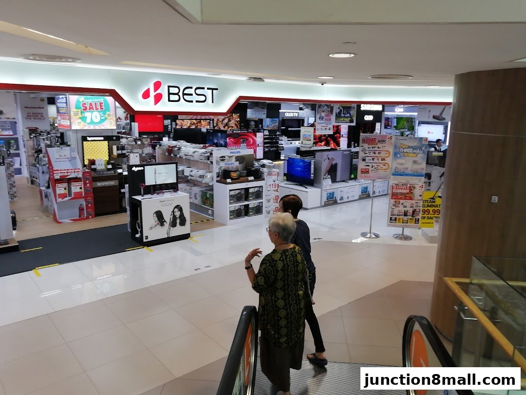 Interior view of a Best Denki electronics store showcasing various appliances and TVs.