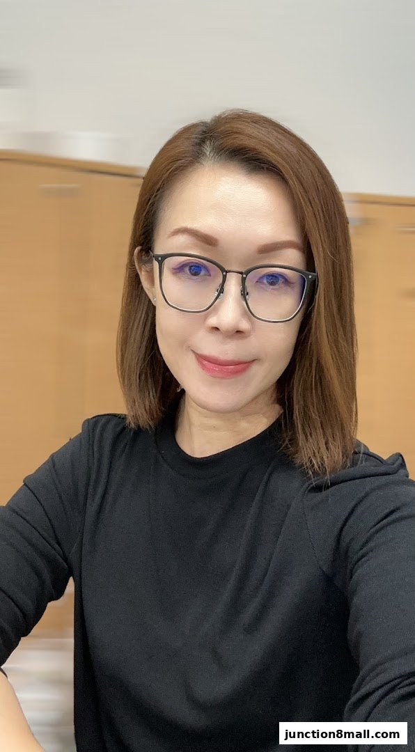 A woman with brown hair and glasses smiles at the camera.