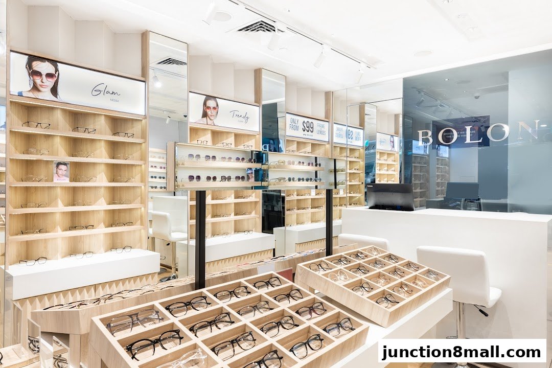Interior of a modern eyewear shop with shelves displaying various eyeglasses and promotional signs.