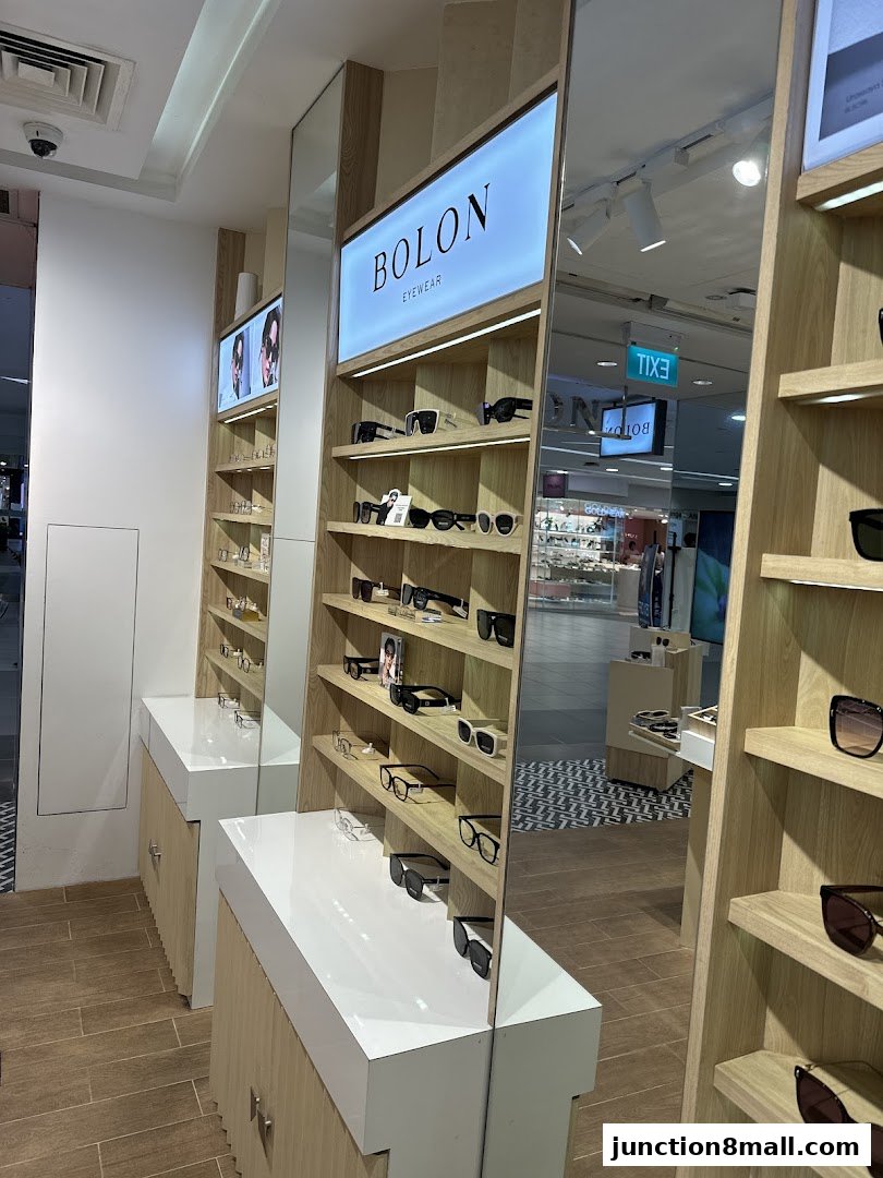 Interior view of a Bolon Eyewear shop showcasing various sunglasses and eyeglasses on display shelves.