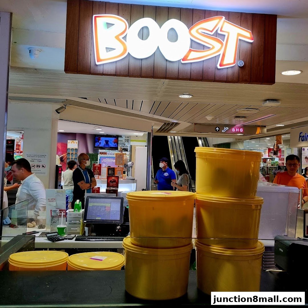 The entrance of a Boost Juice shop with staff and customers visible.