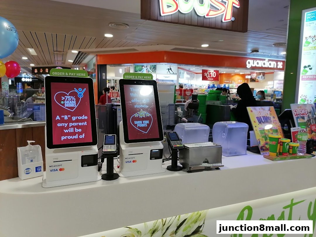 Boost Juice Junction 8 shop counter with ordering kiosks and promotional displays.