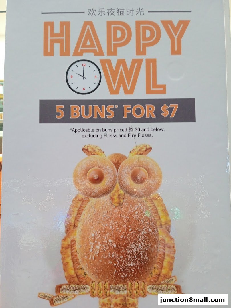 A promotional sign for BreadTalk featuring a "Happy Owl" bun deal.